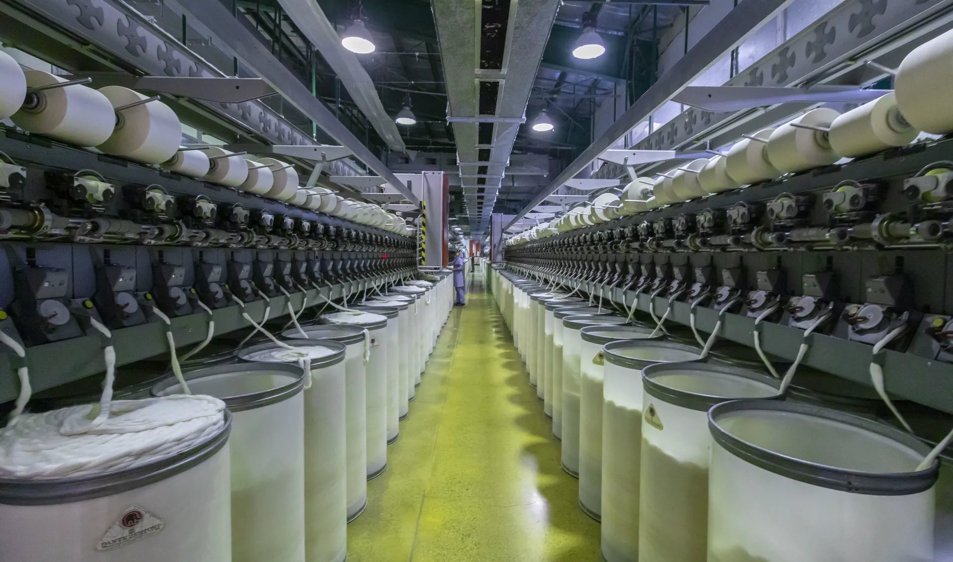 Textile material moving through a controlled production process